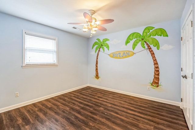 unfurnished room with ceiling fan and dark wood-type flooring