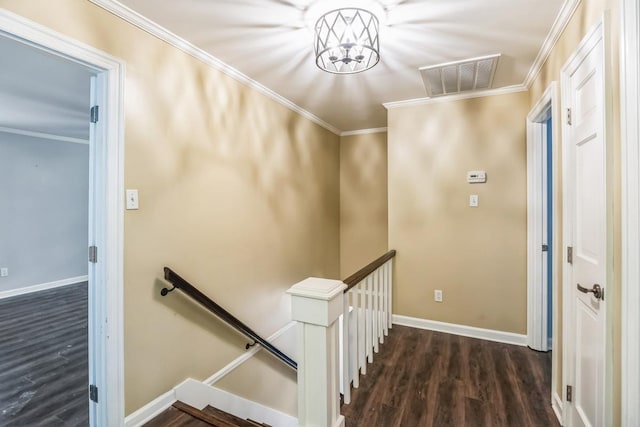 staircase with wood-type flooring and ornamental molding