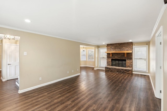 unfurnished living room with a fireplace, dark hardwood / wood-style floors, and crown molding