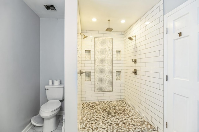 bathroom with toilet and tiled shower