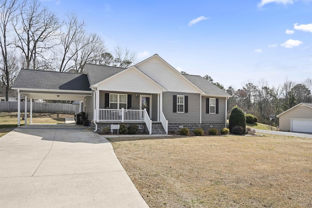 view of front of house with concrete driveway, fence, a porch, a carport, and a front yard