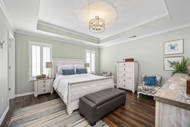 bedroom featuring a tray ceiling, dark wood-style flooring, multiple windows, and a notable chandelier