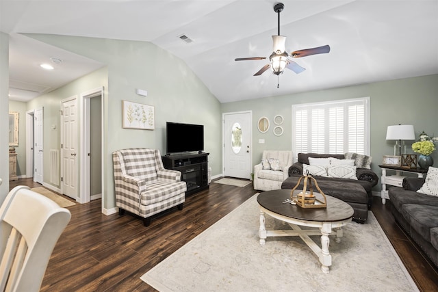 living area featuring lofted ceiling, ceiling fan, dark wood-type flooring, visible vents, and baseboards