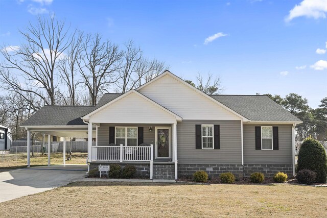 view of front of house with a shingled roof, covered porch, fence, an attached carport, and driveway