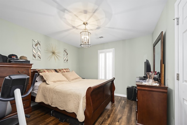 bedroom featuring dark wood-style floors, baseboards, visible vents, and a notable chandelier