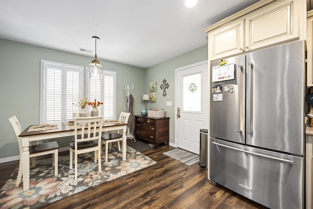 dining room featuring dark wood-style floors, baseboards, and visible vents