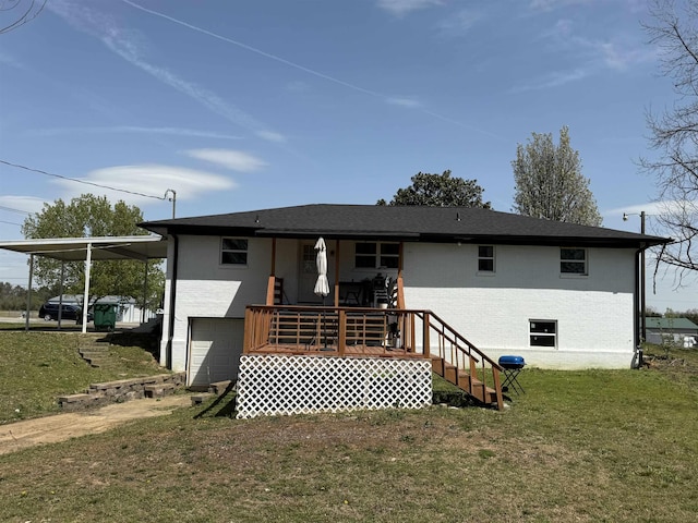 back of house featuring an attached garage, brick siding, a yard, and stairway