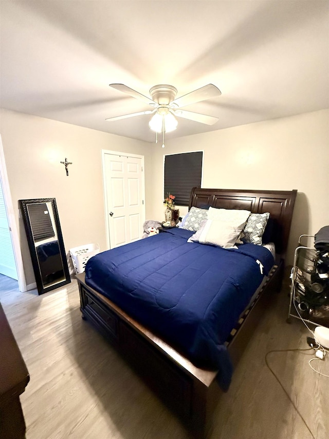 bedroom with light hardwood / wood-style floors and ceiling fan