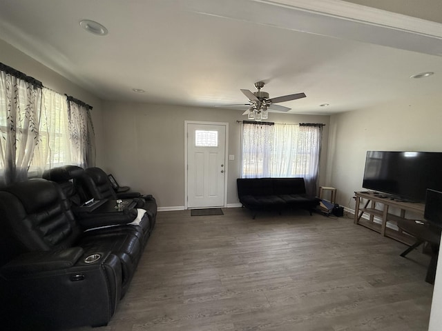 living area with ceiling fan, baseboards, wood finished floors, and recessed lighting
