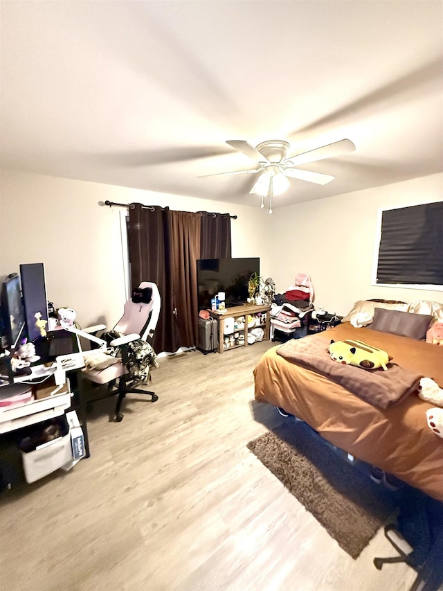 bedroom with ceiling fan and light wood-type flooring