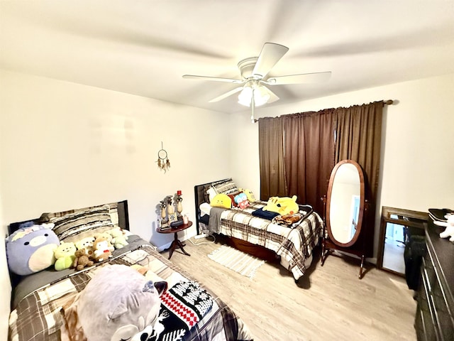 bedroom featuring light wood-type flooring and ceiling fan