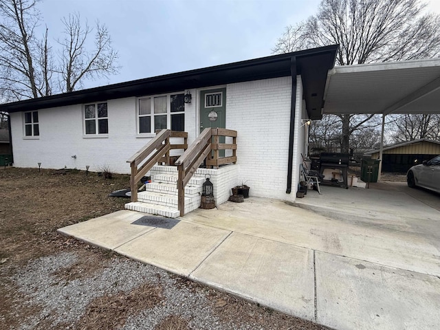 ranch-style home featuring a carport