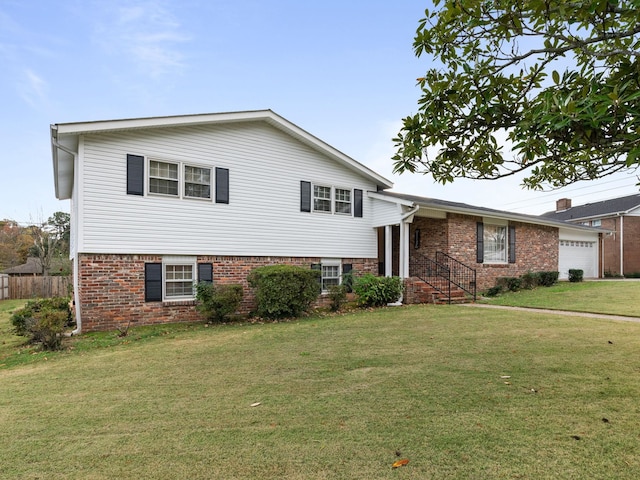 split level home with a garage and a front lawn