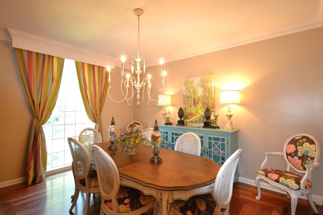 dining room featuring baseboards, wood finished floors, and an inviting chandelier