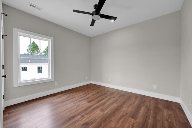  - empty room with wood finished floors, a ceiling fan, and baseboards