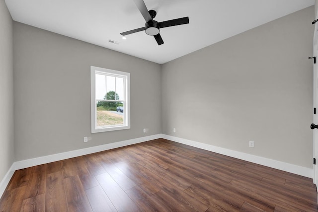  - spare room featuring baseboards, dark wood-style flooring, and a ceiling fan
