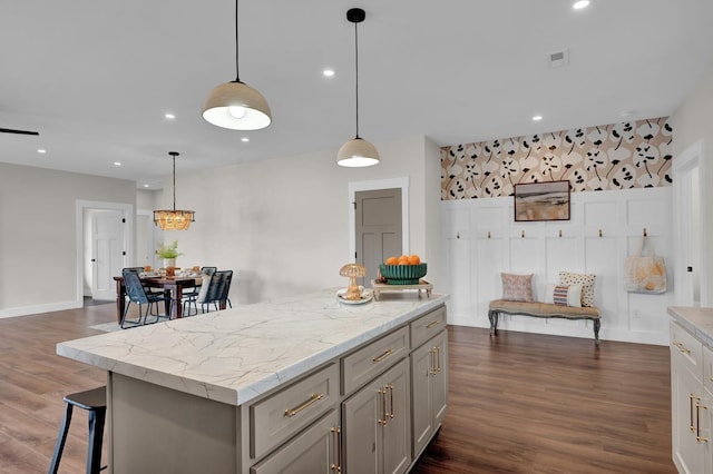 - kitchen featuring gray cabinetry, a kitchen island, dark wood finished floors, recessed lighting, and decorative light fixtures