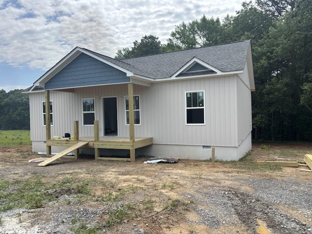 - view of front of home featuring roof with shingles and crawl space