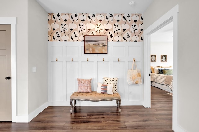  - sitting room with wood finished floors, baseboards, and an accent wall