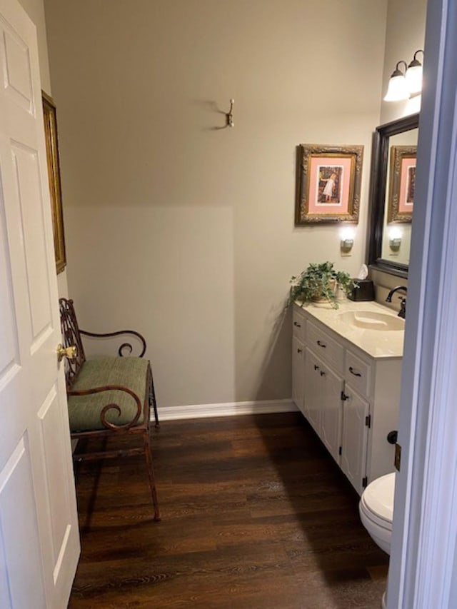 bathroom featuring hardwood / wood-style floors, vanity, and toilet