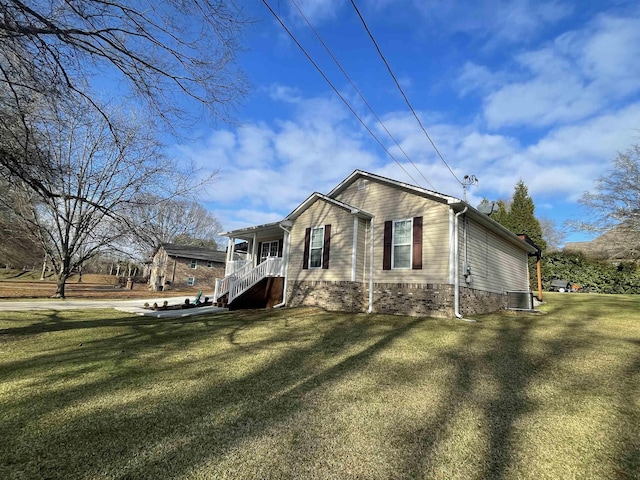 view of home's exterior with central AC and a lawn