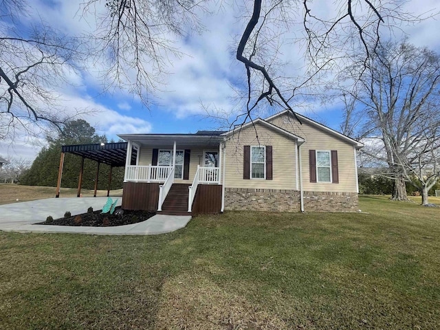 view of front of property with covered porch, a front yard, and a carport