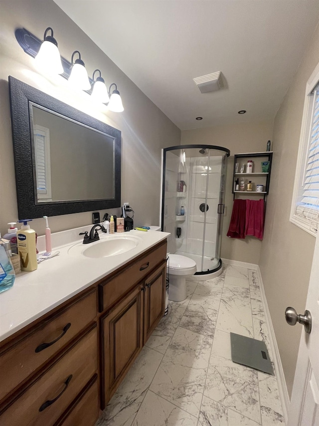 bathroom with vanity, toilet, and walk in shower