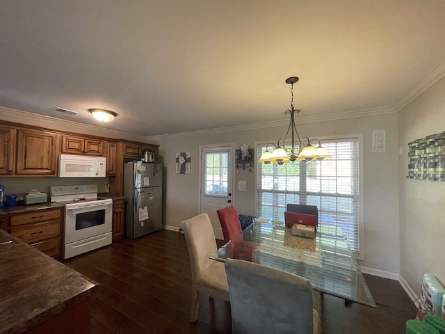 kitchen featuring ornamental molding, white appliances, decorative light fixtures, a chandelier, and dark hardwood / wood-style floors