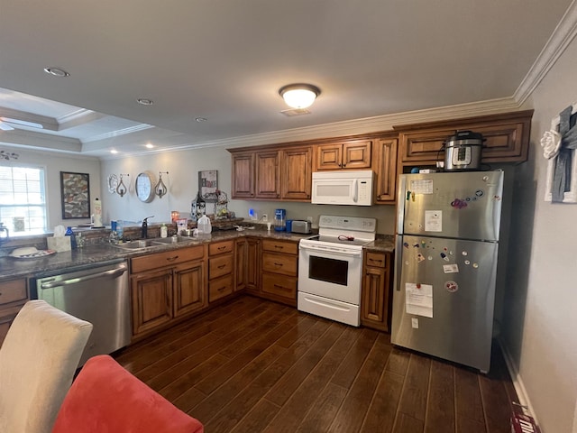 kitchen featuring sink, dark hardwood / wood-style floors, kitchen peninsula, crown molding, and appliances with stainless steel finishes