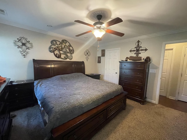 carpeted bedroom featuring ceiling fan and ornamental molding