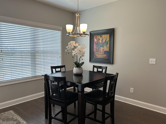  - dining room with a chandelier, baseboards, and dark wood-style flooring