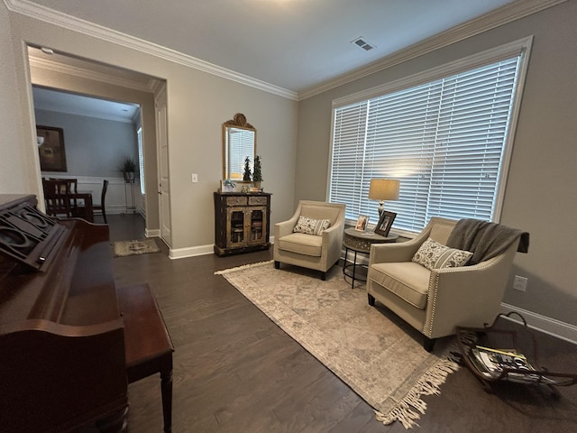  - living area with crown molding, baseboards, wood finished floors, and healthy amount of natural light