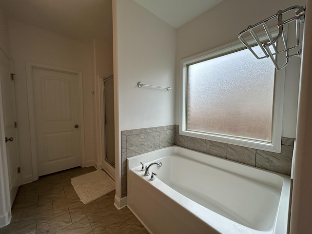  - full bath featuring a garden tub and a shower stall