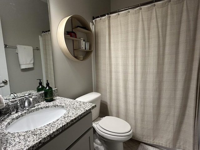  - bathroom featuring toilet, vanity, tile patterned floors, and curtained shower