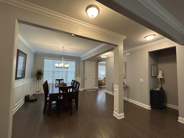  - dining room featuring a chandelier, dark wood-style floors, healthy amount of natural light, ornamental molding, and baseboards