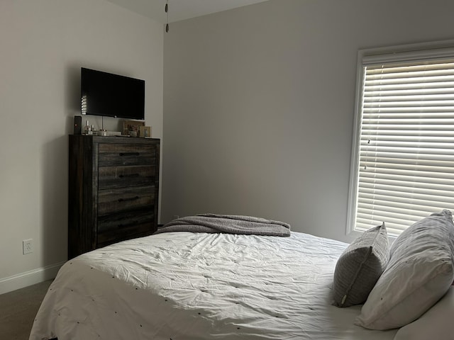  - carpeted bedroom with baseboards