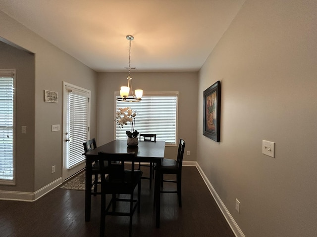  - dining room with baseboards, a chandelier, and dark wood-type flooring