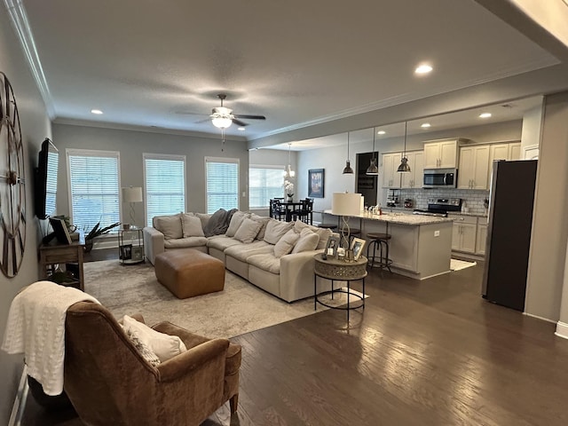  - living area with dark wood-style flooring, crown molding, ceiling fan, and recessed lighting