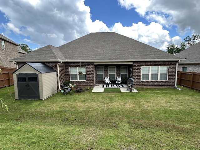  - back of house with brick siding, a shingled roof, and a patio