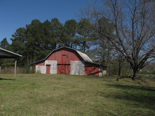 view of barn with a yard