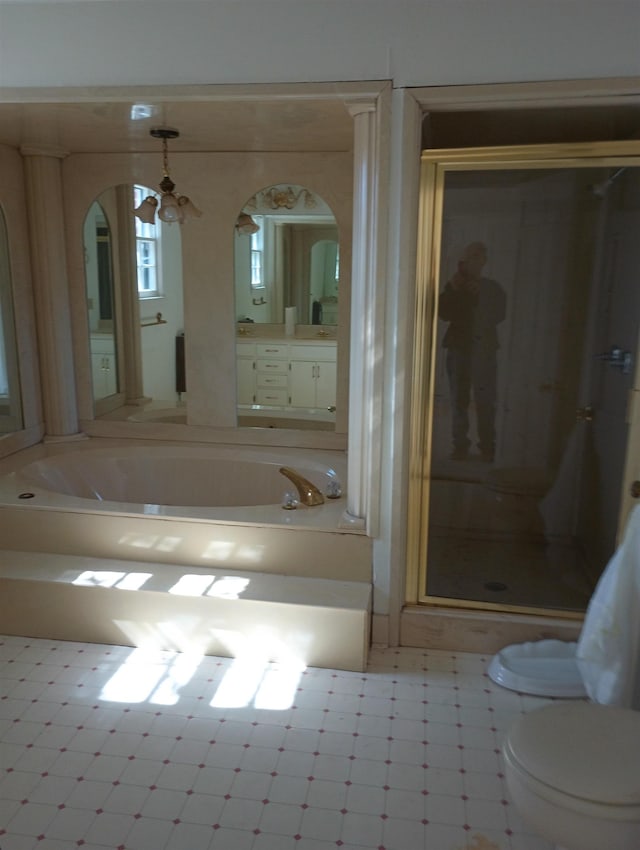 full bathroom with vanity, toilet, and a stall shower
