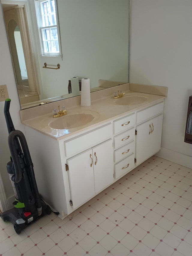 full bathroom featuring a sink, double vanity, and tile patterned floors