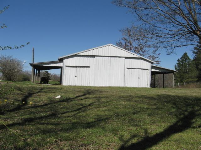 view of pole building with a lawn