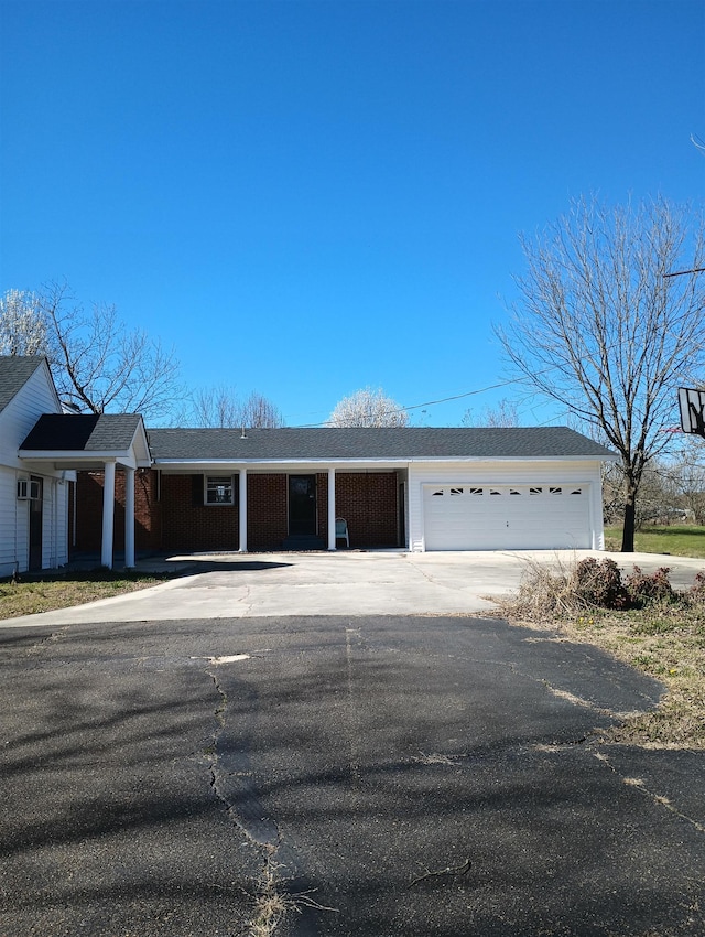 single story home with driveway and a garage