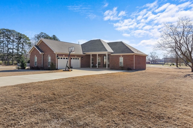 view of front of home with concrete driveway, brick siding, a front lawn, and an attached garage