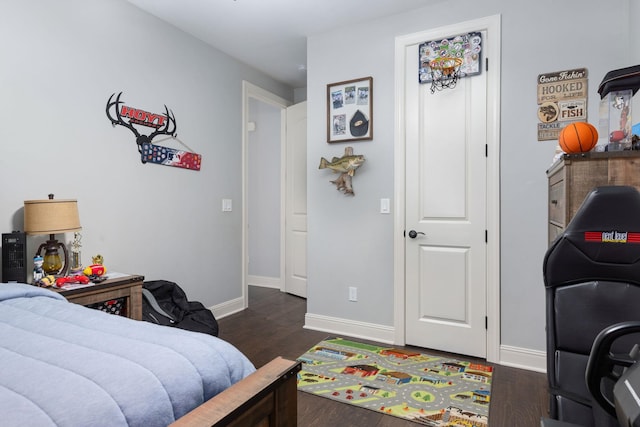 bedroom with baseboards and dark wood-style floors