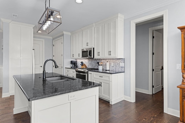 kitchen featuring white cabinets, an inviting chandelier, a sink, and appliances with stainless steel finishes