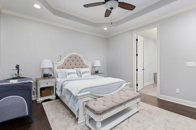 bedroom featuring recessed lighting, a raised ceiling, ornamental molding, baseboards, and hardwood / wood-style flooring