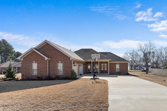 view of front of house with a garage, driveway, and brick siding