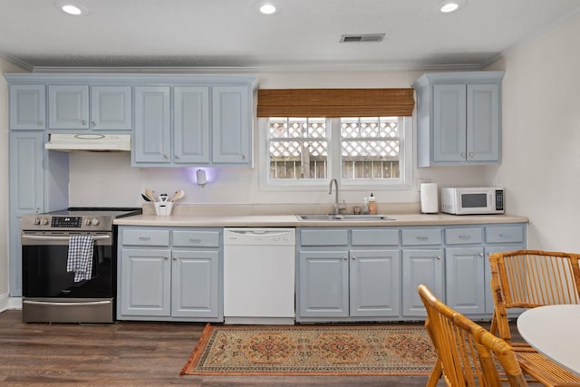 kitchen with dark wood-type flooring, sink, white appliances, and a textured ceiling